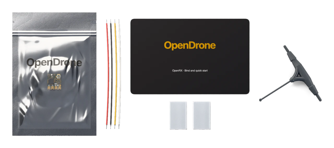1× OpenRX board, 1× Silicone hook-up wire set, 30 AWG, four wires, 1× Heat-shrink sleeve, clear, two-piece, 1× 2.4 GHz U.FL T-dipole antenna, 1× Bind and quick-start card, 1× ESD bag